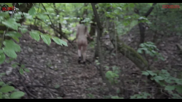 Mel walks naked in the wood